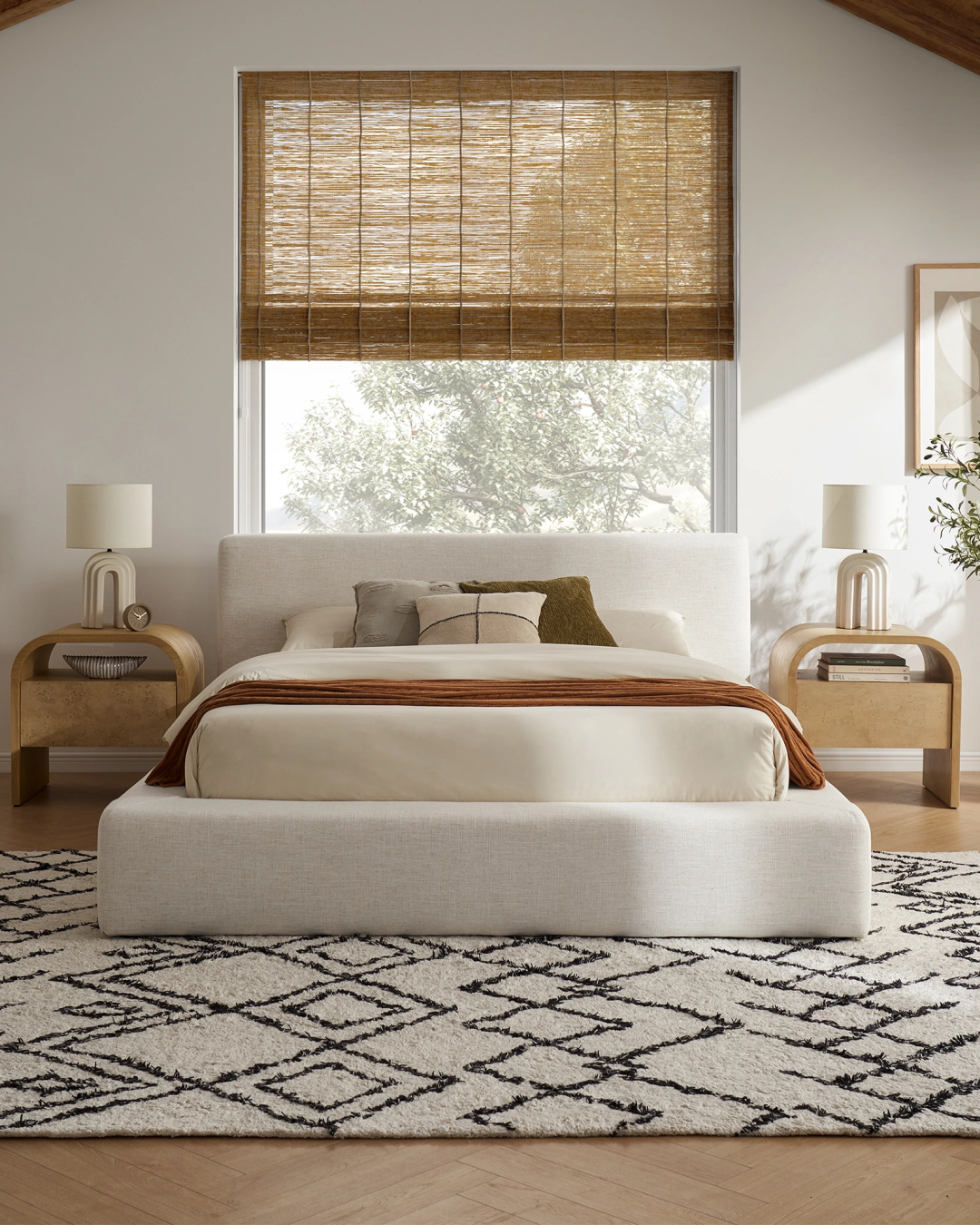 Front view of an upholstered platform bed with storage