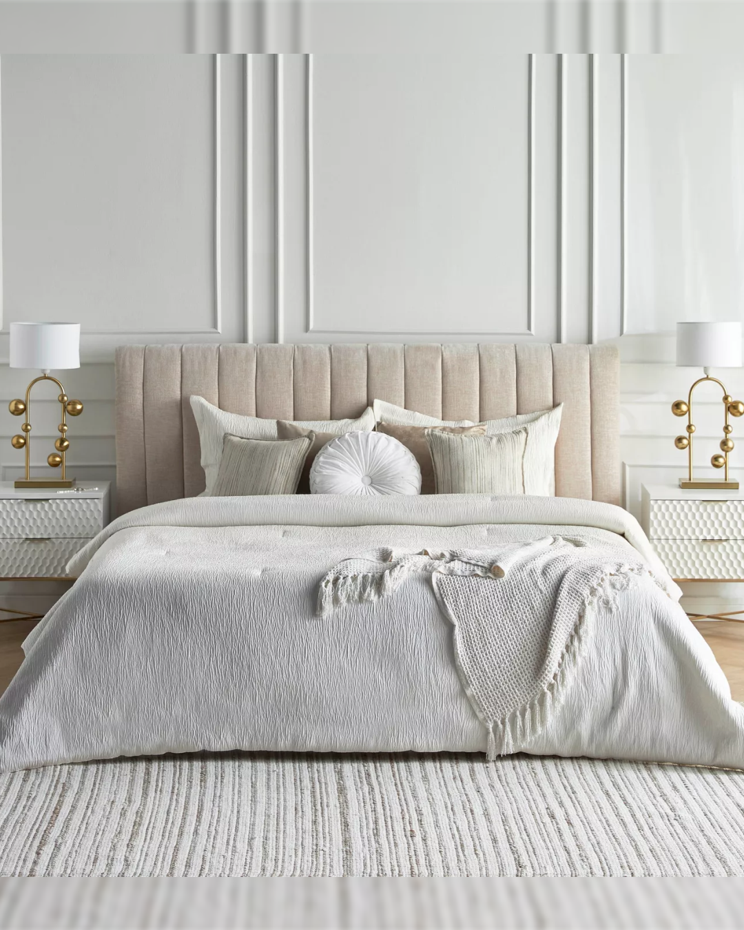 Front view of Dunlyn bed with vertical fluted upholstered headboard in beige fabric.
