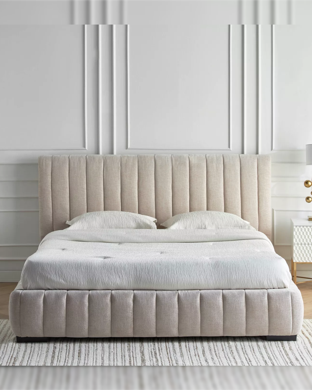 Full-frame front view of the Dunlyn bed showing fluted headboard and matching footboard in beige upholstery.