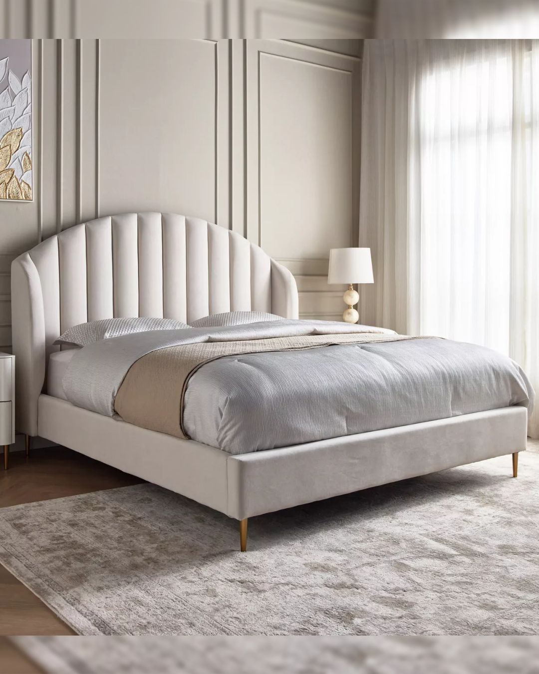Side angled view of the Foxgate bed highlighting arched vertical channeled headboard and velvet upholstery