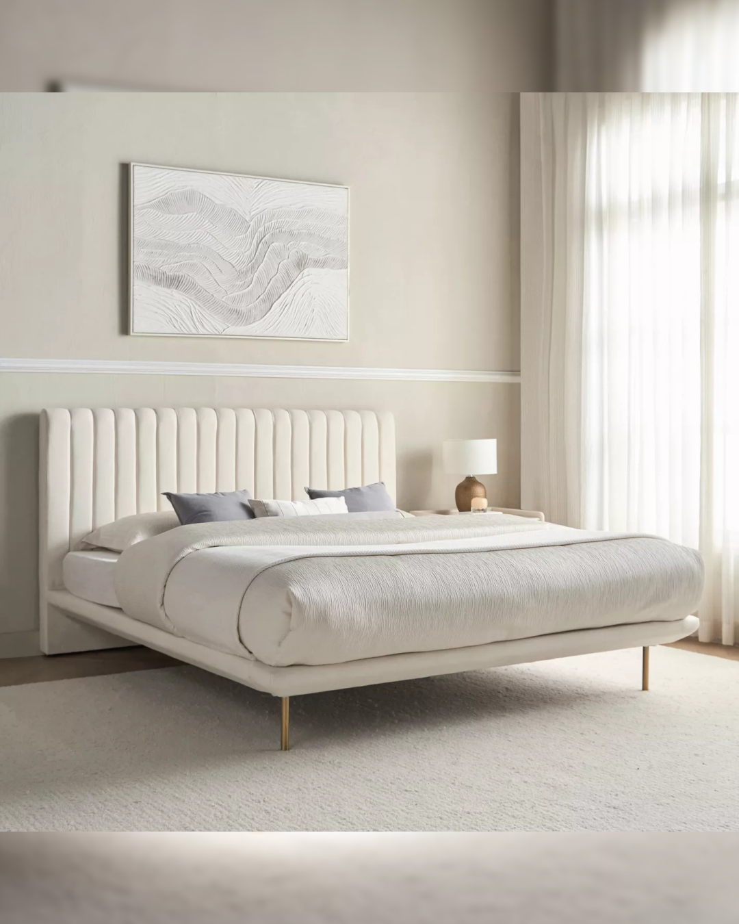Angled side view of the Halgate bed showing slim base, vertical headboard, and brass legs