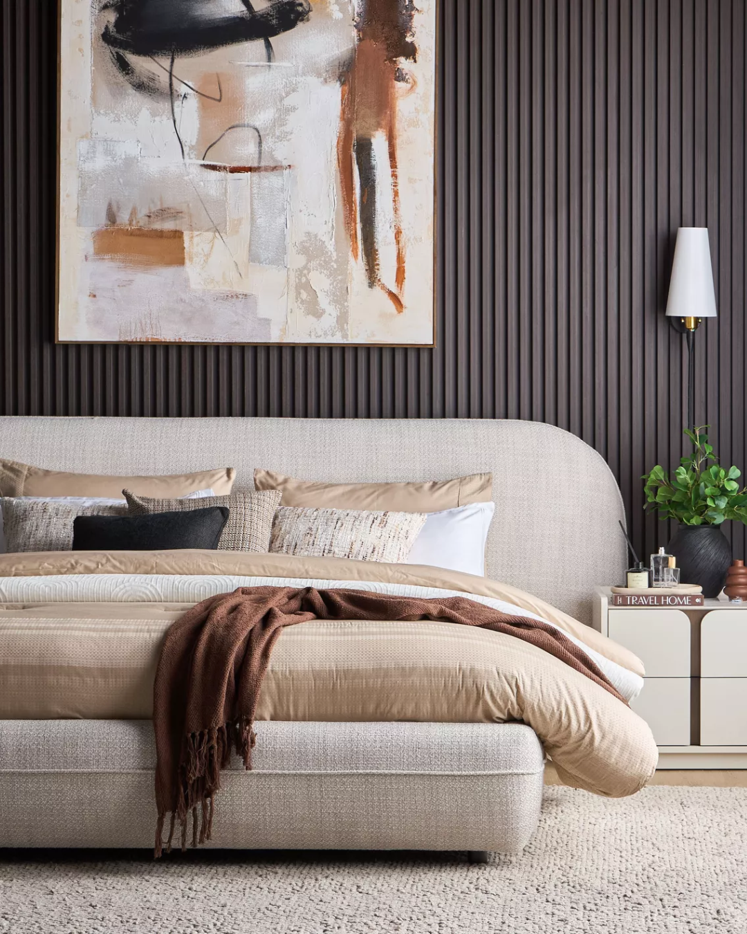 Side angle of Oakdale bed styled with layered bedding and neutral tones