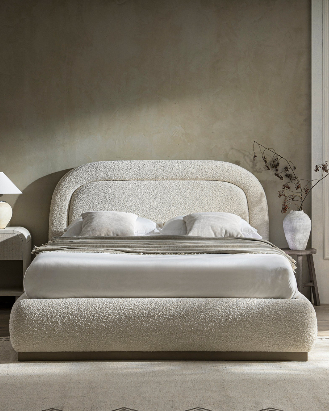 Front angled room view of Whitelyn bed with softly curved padded backrest