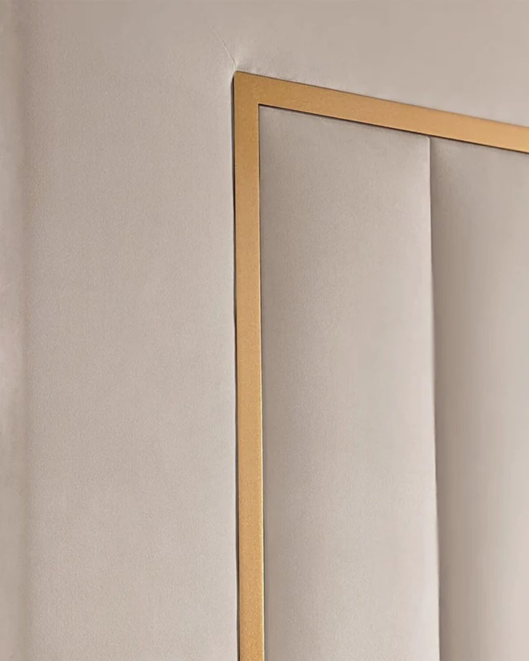 Close-up showing gold trim and padded fluted paneling